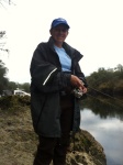 A break in the rain. Waders, jacket and cap. This girl likes to fish!