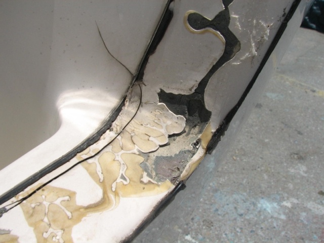 Initial cuts on stb side of transom.  Note the crack which starts in the spash well and then goes down the top of the transom.