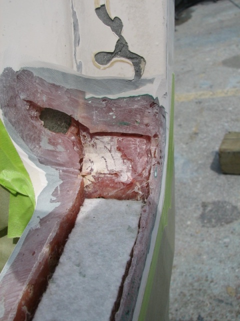 To the right of the previous photo.  We have put a piece of roving on the back side of the hole, to re-inforce the transom and splash pan.