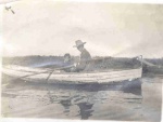 A skiff in Long Beach Harbor with CR Austin in a suit in 1907