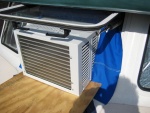 $ 89, 5,000 BTU AC unit in the opening window of CD 25.  Sunbrella snaped on the inside of the frame and draped over the sides to keep water out.