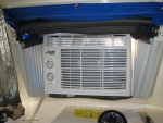 Inside of cabin with 5,000 BTU air conditioner and sunbrella snapped in place.  The fan fold \