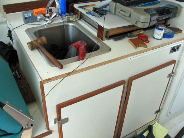 galley counter, no bedding compund, the fiddles came off easily.  The plywood edges will be epoxy sealed, and the fiddle screwed in place with a high bond urethane adhesive