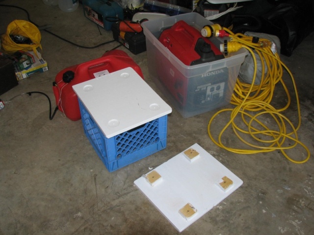 Honda Generator in storage bin, two cords--15 amps #12 and 20 amp #10 with Marinco 3 prong boat plug  Crate with the generator platform on top, and the extra fuel tank upside down showing the cleats