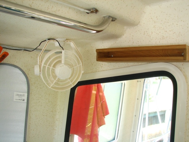 Spice rack and fan over stove in galley