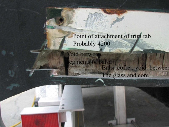 annotated void in the core at the transom.  This core in the bottom of the boat should be separated from the transom core by at least a layer of glass and should extend to the extreme end of the boat, so there is no voids, where water can trap.  The solution is to fill this gap with solid glass.