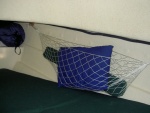 Gear storage hammocks in v-berth.  Oak bases with hooks are epoxied to the side of the  hull.  Very handy and they don't intrude very much into the berth.