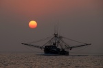 Shrimper at sunset, heading out as we were heading in