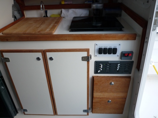 P1000485 standard 08 Venture Interior w std. butane stove, cutting board has starboard strips underneath that fit into the sink to keep it from sliding around while underway
