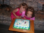 Claire and Grace Callahan (OTTER) decorate a blue/green C-DORY Cake.  Note the loose tooth!  Is it gone yet Grace?