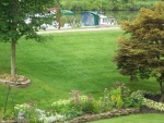 Beautiful lawn and gardens at the Adams Basin B&B with a couple of C-Dories at their dock.