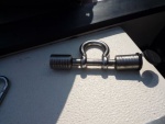Drilled out shackle to fit a trailer pin lock, chain slips onto shackle pin lock goes thru a welded eye mounted to the stainless steel plate
