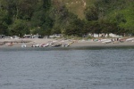 Race boats assembled on the beach.
