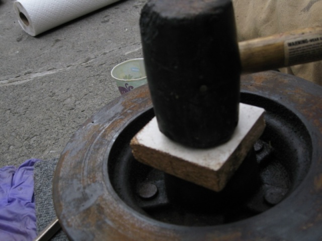 Us a block of wood and rubber mallet to gently tap the seal into place.  Work around the edges with the mallet and frequently check to make sure its going in straight.