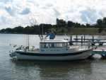 (Not For Hire) Boat at dock using rocket launchers and rod holders on transom board.