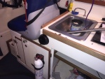Hot air vent installed just behind helm seat, on front of cabinet under sink.