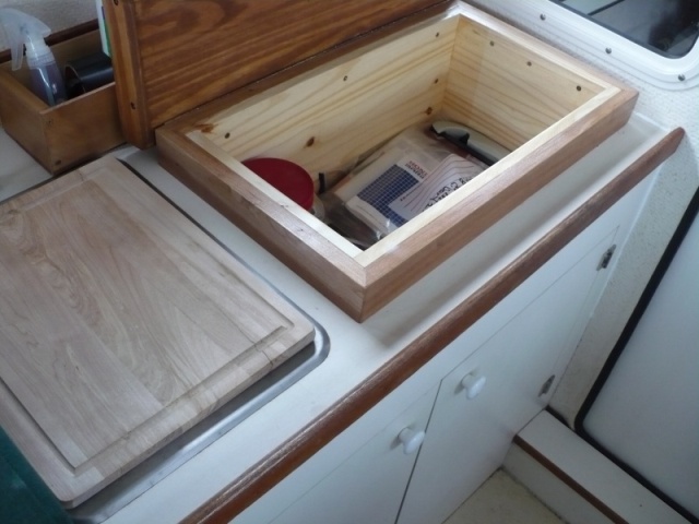 Top lifts up and there is a nice storage area under the cutting board