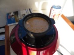 I found a tiny Dutch oven at a thrift store.  Here I have filled it with cornbread batter and it's ready to bake.  The induction burner heats up the cast iron Dutch oven just like it was inside a regular oven.  