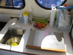 The Galley top is made of laminate.  The Faucet is actually a very high quality Euro-design, with ceramic valves.  The faucet contains a switch that starts the pump and allows for variable water flow.  To the right is the Wallas two-burner diesel stove.  It boils water quickly, and is powerful enough to heat both the cabin and the enclosed cockpit.  Yet it can be set to low speed, and keep everyone in the cabin comfortable.  USE DIESEL FUEL!  Les told us that diesel has more btu's of heat per unit and has a longer shelf life than kerosene (2 years as opposed to 6 months or so.)  And it is a miser on fuel.  We only burned about 1.5 gallons for the three weeks we were on the boat, and we used it to heat the cabin for 2 to 4 hours per day.