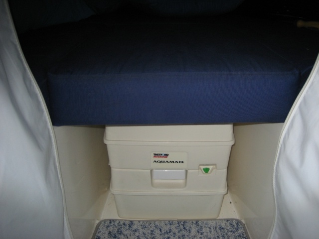 Potty with v-berth cushion in place. Height is tight fit but doable.