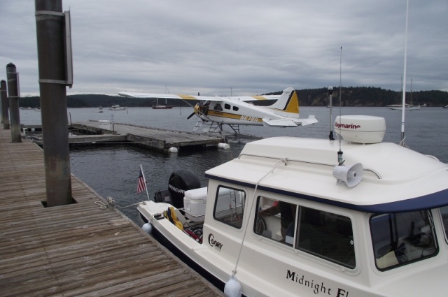 Midnight Flyer tied up near a float plane.