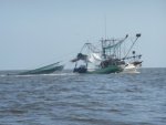 Shrimper pulling up his nets.