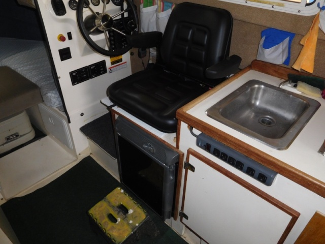 
Helm Seat turned to aisle is used for extra seating when guests visit for Dock Tails.
Foot support is an RV step which is normally allows stepping from swim step.