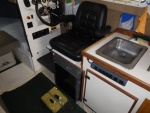 
Helm Seat turned to aisle is used for extra seating when guests visit for Dock Tails.
Foot support is an RV step which is normally allows stepping from swim step.