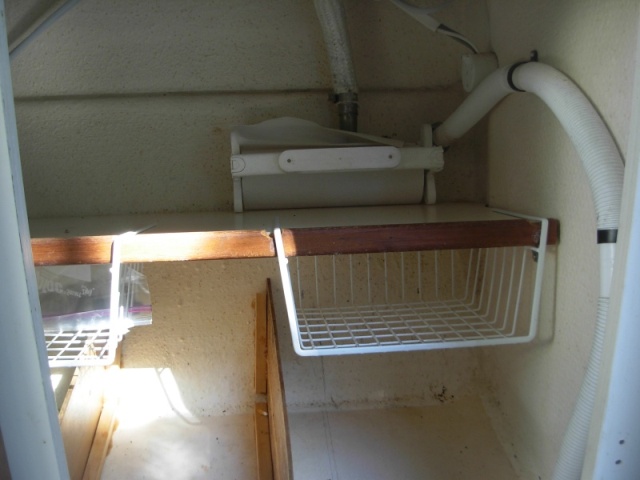 Under sink storage.  These baskets are from a hardware store storage supplies.  They are made to slide on to a shelf.  I had to cut notches in the facing of the shelf to get them to fit.  
In the bottom I epoxied vertical 