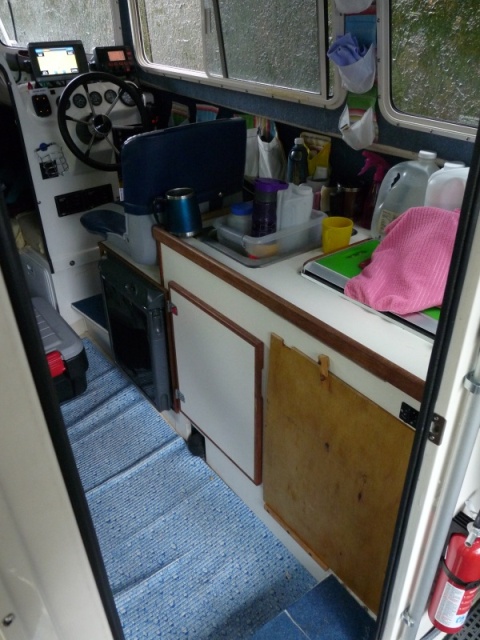 Two Bears in boating mode.  Cabinet door is now a sheet of plywood covering the under sink area.  The arm of the helm seat is off as we found it it often in the way of getting in and out of the 