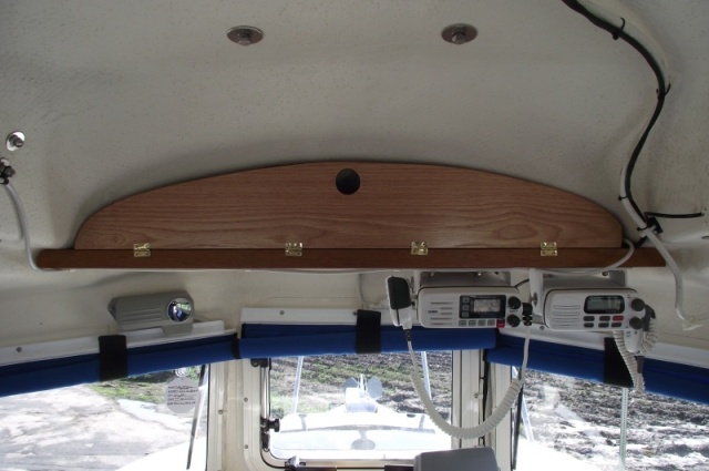 Overhead cabinet door held closed by magnetic catch