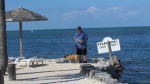 me and deputy dog Lucy out at the beach Black Fin Resort Marathon, a barbecue grille and tables steps down into the water 200 yards from our boat slip.