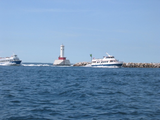 Ferrys rounding harbor entrance to Mackinac Island Harbor