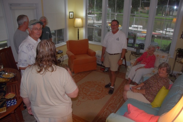 Captain Steve [to the right of the red chair] calling the captains together.