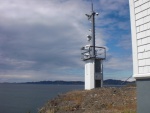 Automated light house, Turn Point, Stuart Island.  In the back ground is South Pender Island, Canada.
