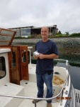 Bill holds a loaf of zucchini bread for him and the crew. Don't need a mutiny on the way home.