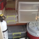 Permanent shelf (middle) and removable storage containers under galley.  Inexpensive way to increase storage area.