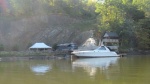 Check it a large motor home, the building complete with fireplace, boat, dock cut into a cliff with a steep access road. Quite a hangout