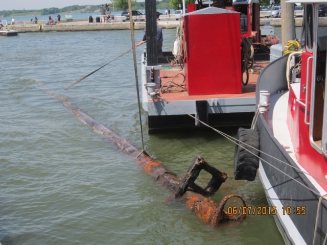 Some say the metal ring and boxed section are the remnants of the crows nest. Another told me that a smaller top section of mast would have been inserted here.