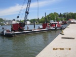 This barge and tug worked pretty slick. The post on each side of it could be lowered into the water up to 20 feet to push into it and hold the barge in place.