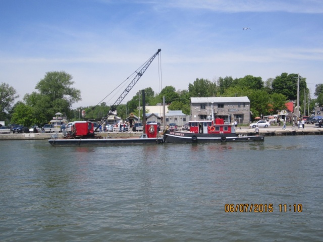 The tug towed it up the river with the mast strapped to the side of the barge where it could rest a while to make sure it was waterlogged before being dropped to the bottom of the lake again.