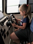 Captain Olivia at the helm (with a little help from Poppa)