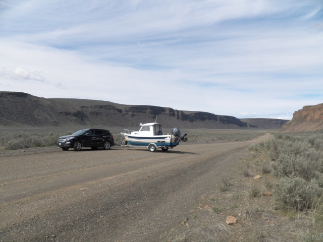 I now have more than 2K miles on the trailer, some on steep gravel roads, and I have never felt the trailer push on me when stopping.  I can hardly even tell that it's there.  Except the bouncing on roads like this.