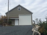 New Garage. (view from the east). Man Door and Boat access. Boat door is 14' high and 12' wide.  