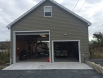 Garage, view from the west. The boat can be driven thru the garage, so no need to back up and turn around. The door on the right is 8' high and 10' wide.