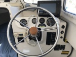 Helm station with Garmin 741xs chartplotter/sounder, FlowScan gph meter, voltmeter, engine tit and trim gauge, multi function tachometer gauge, Lev-O-Gage, Icom VHF radio, trim tab controls, rocker switches and two 12 volt cigarette adapters.