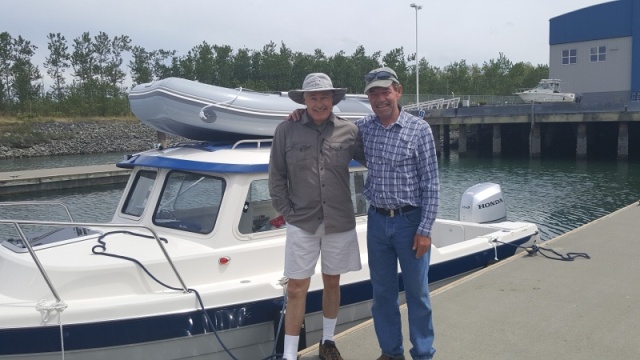 Brock with his buddy Mark.  Check out that beautiful brand spanking new boat and motor, Honda 150!