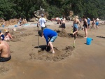 Here I am digging a hole in the sand (everybody brings a shovel).