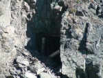 Old mine shaft on lake edge of Lewellyn Inlet