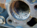 I switched to industrial vinegar (10%) and later to muriatic acid.  That cleaned things up in a hurry.  I actually soaked the old thermostat clean and kept it for a backup.  A car thermostat, which doesn't get any build up, is good for decades.  Why not an outboard thermostat with the build up dissolved periodically?